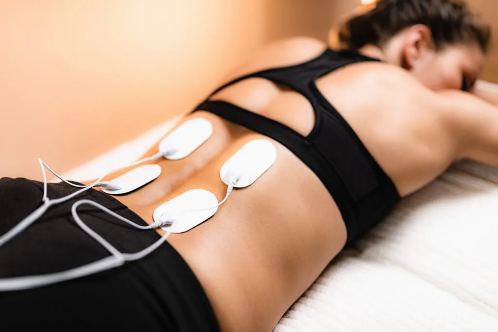 TENS electrodes applied to lower back during treatment